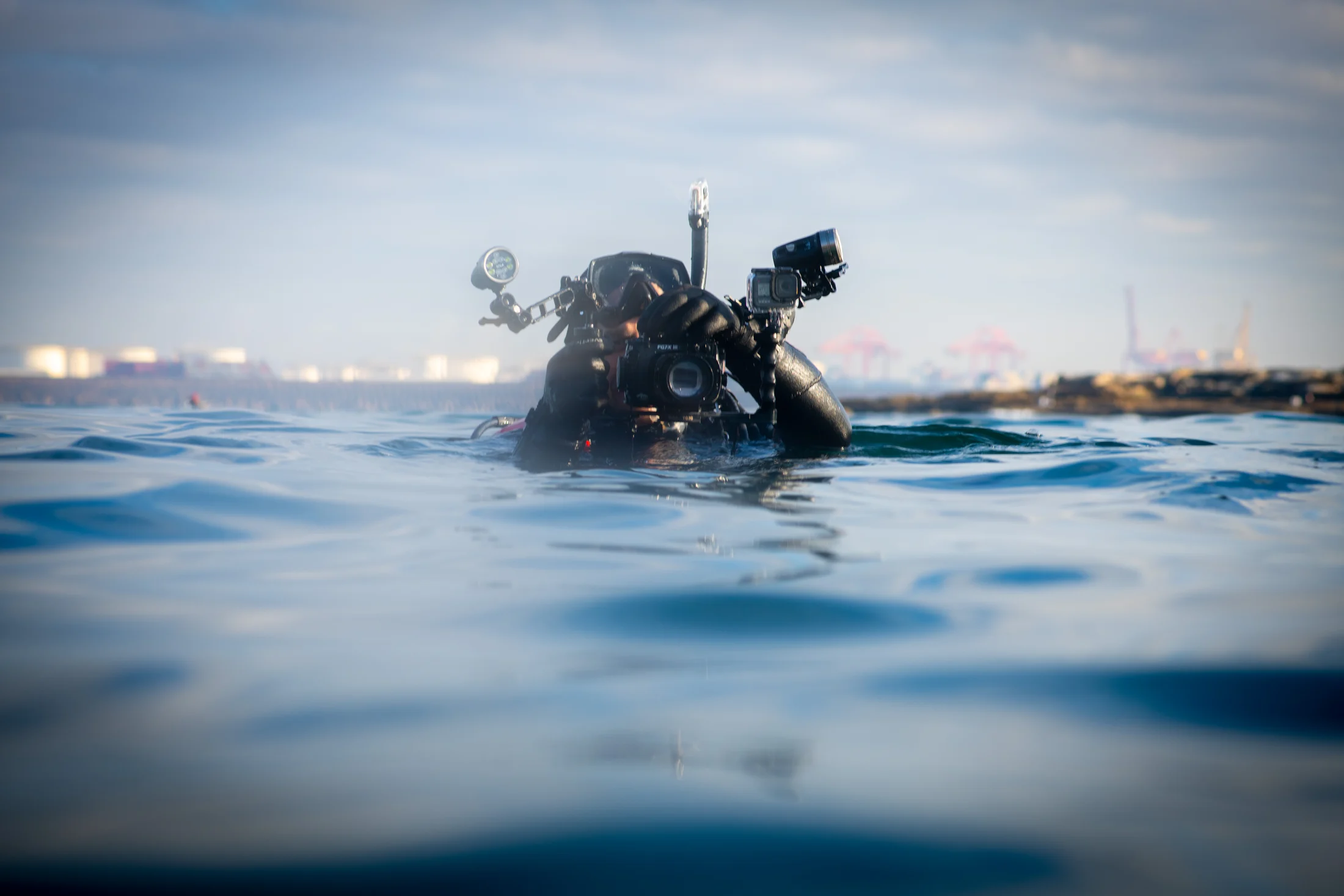 Diver at the water surface by Croome Photography