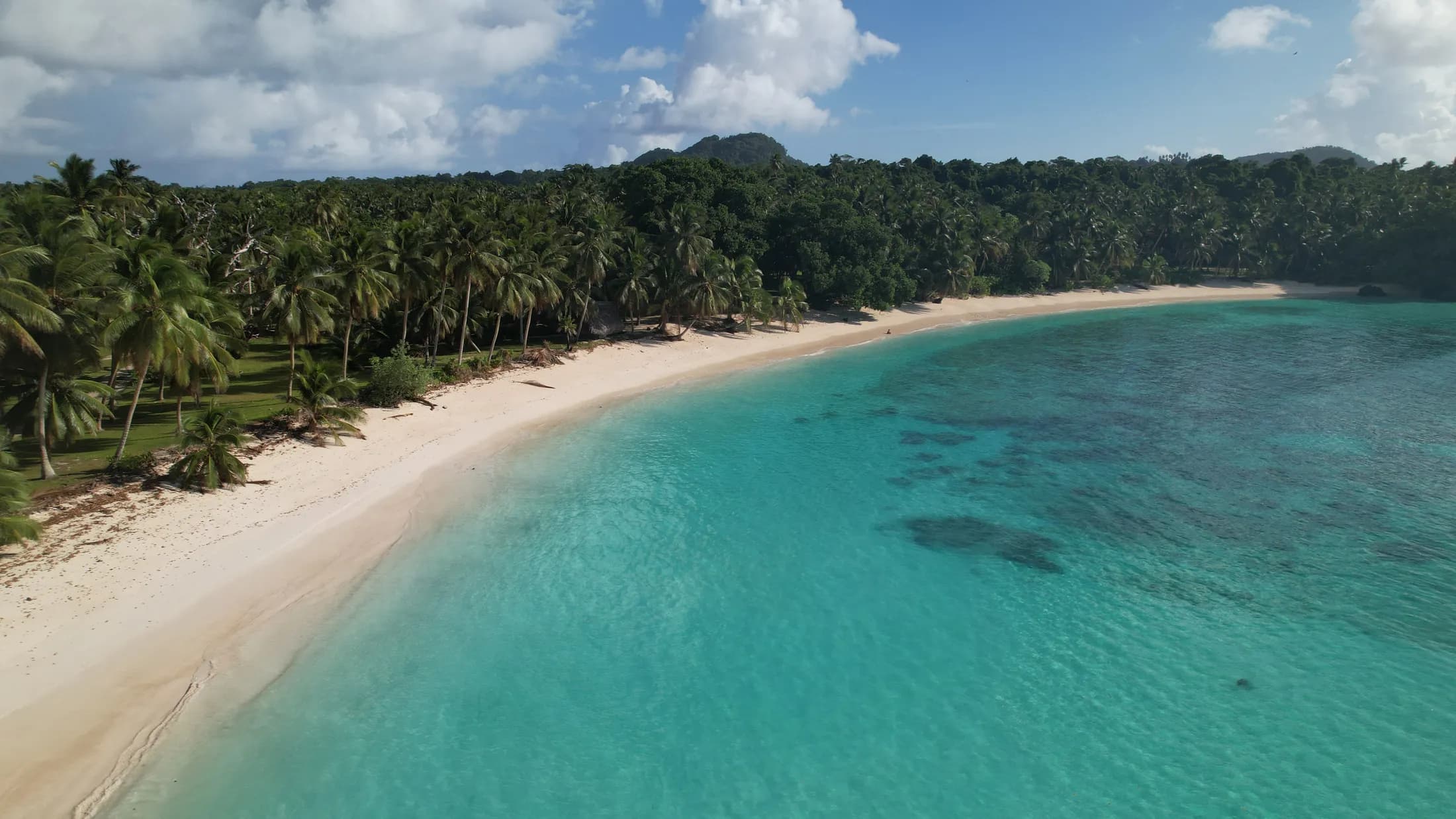 Aerial view of a white sand bay and turquoise water by Croome Photography